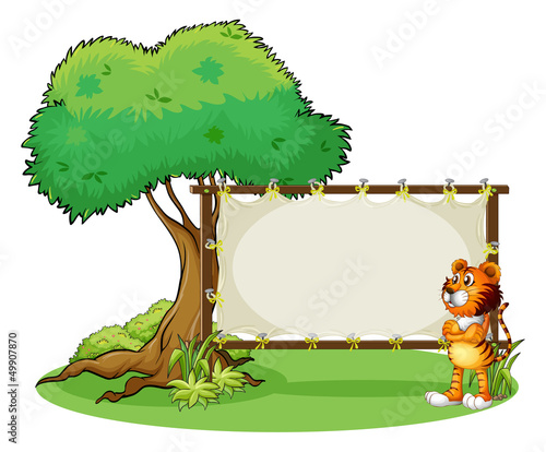 A tiger beside the empty framed signboard