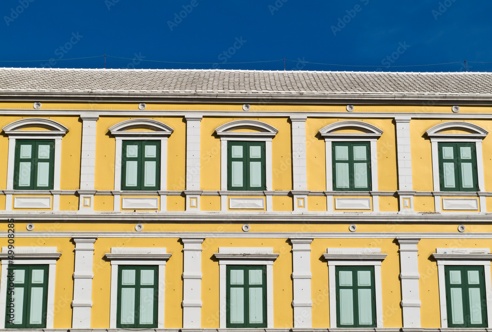 Fototapeta premium Green window on the yellow wall old Thai ancient building