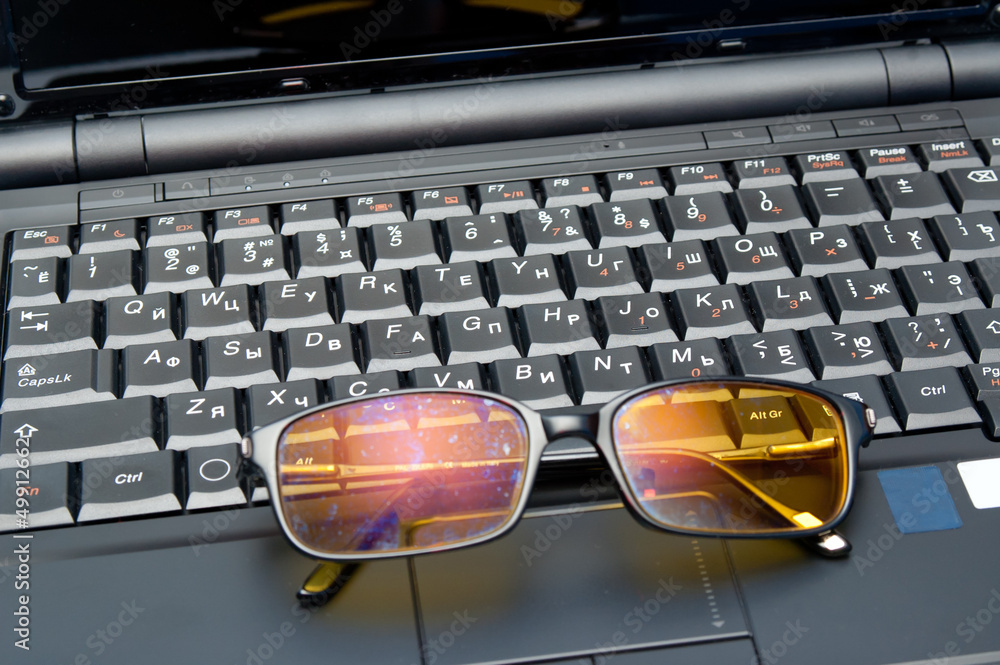 Keyboard and eyeglasses closeup Keyboard and eyeglasses closeup