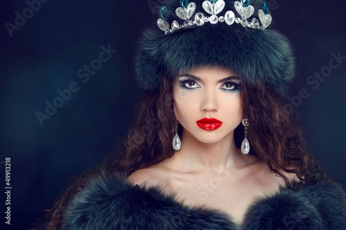 Jewelry and Beauty. Beautiful woman model wearing in fur coat.
