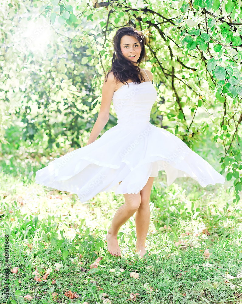 Beautiful young woman dancing in the morning bright summer orcha Beautiful young woman dancing in the morning bright summer orcha