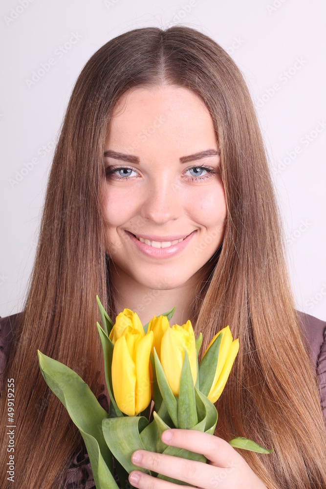 Beautiful woman with long hair with yellow tulips Beautiful woman with long hair with yellow tulips