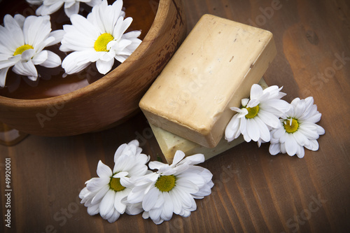 Spa soap with bowl of water and flowers
