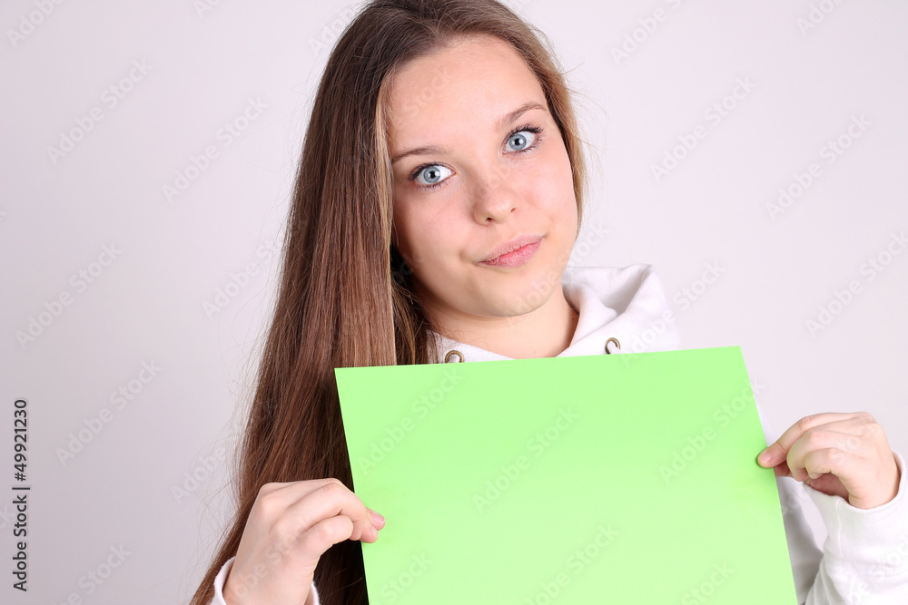 teenage girl wearing sport clothes and showing white blank card teenage girl wearing sport clothes and showing white blank card
