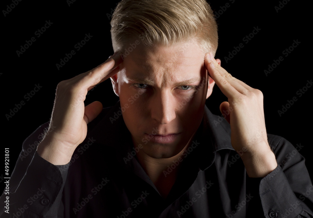 Low key portrait of unhappy young man. Low key portrait of unhappy young man.