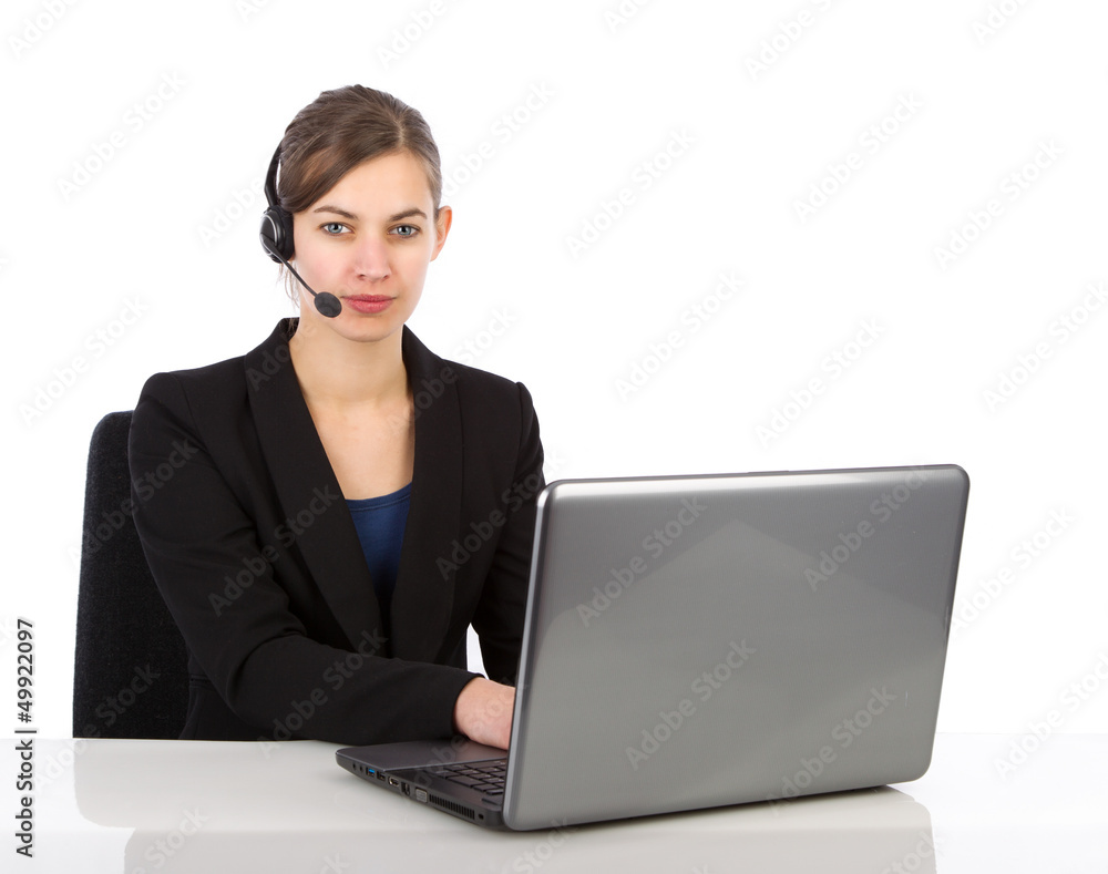 Attractive business woman with headset working on a laptop Attractive business woman with headset working on a laptop