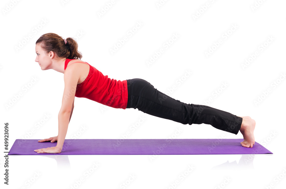 Young female doing exercises on white