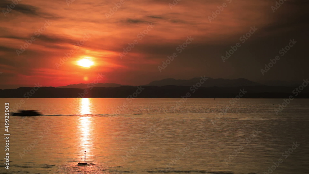 Sunset over Garda lake. Fast motion effect. Sunset over Garda lake. Fast motion effect.