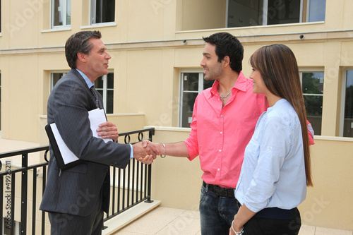 Estate agent shaking customers hand