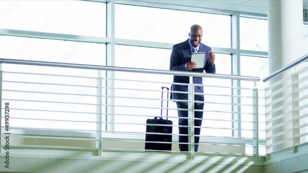 Happy African American businessman using tablet Happy African American businessman using tablet