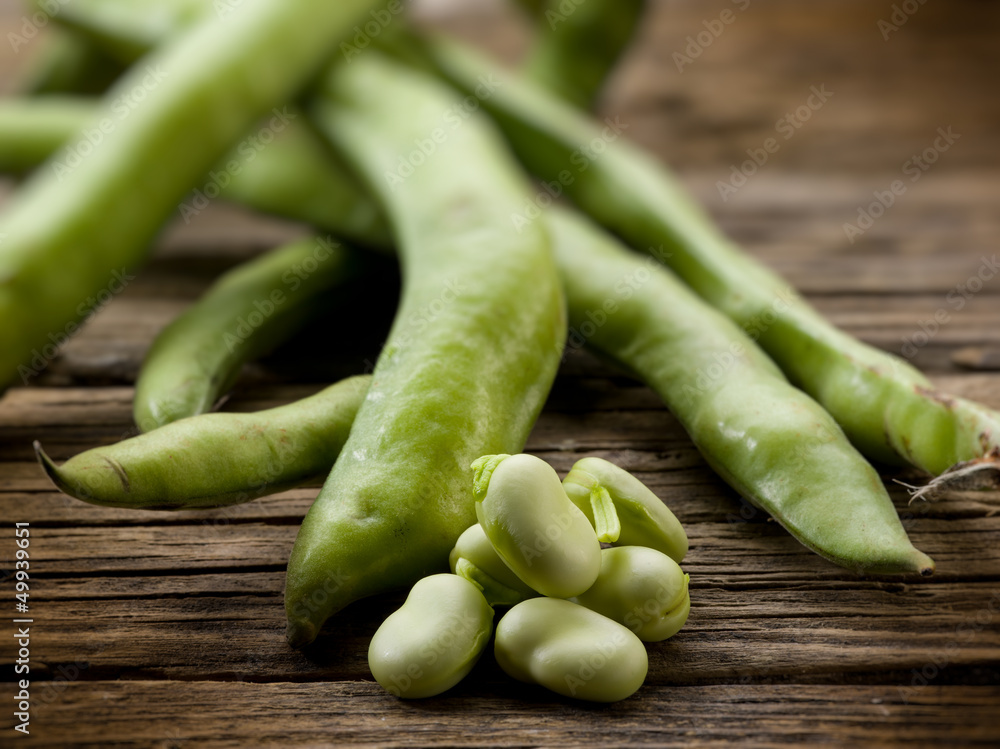 fresh beans broad over wood background, selective focus fresh beans broad over wood background, selective focus