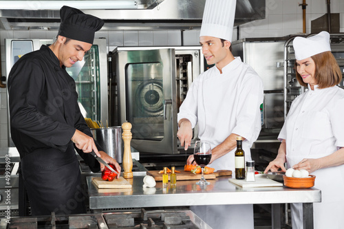 Chefs Working In Commercial Kitchen