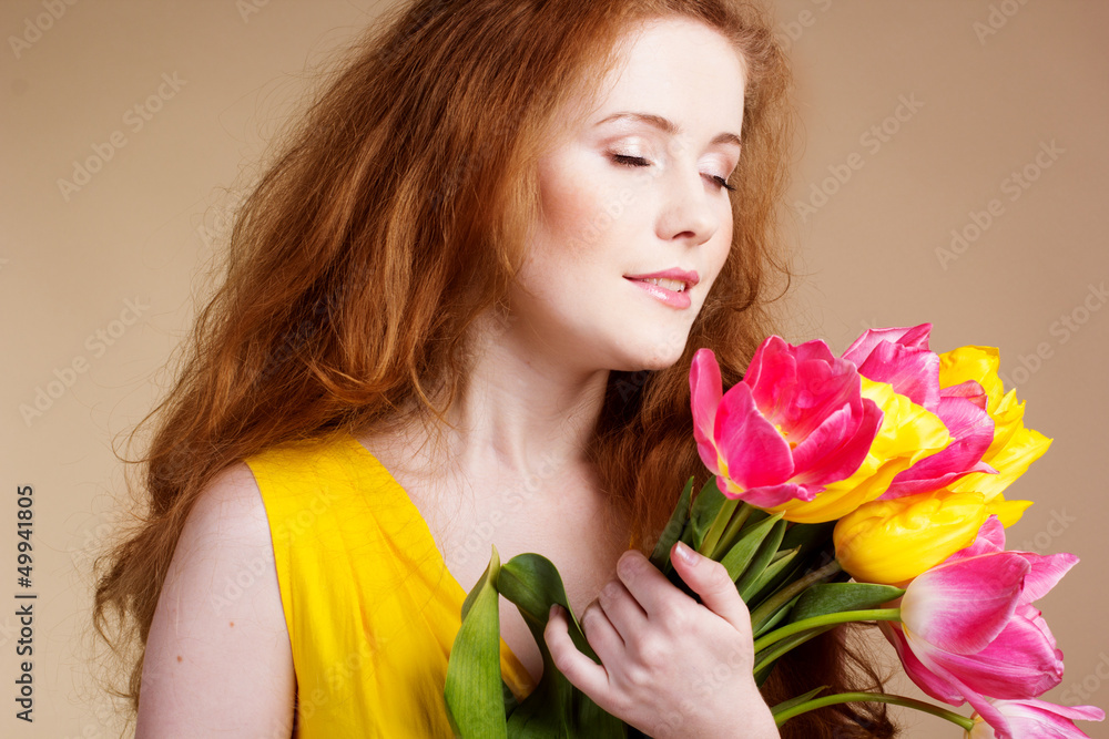 Beautiful redheaded girl with tulips