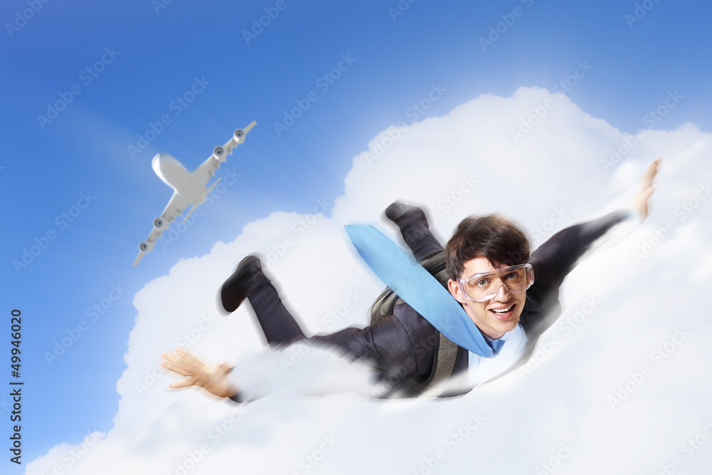 Young businessman flying with parachute on back Young businessman flying with parachute on back