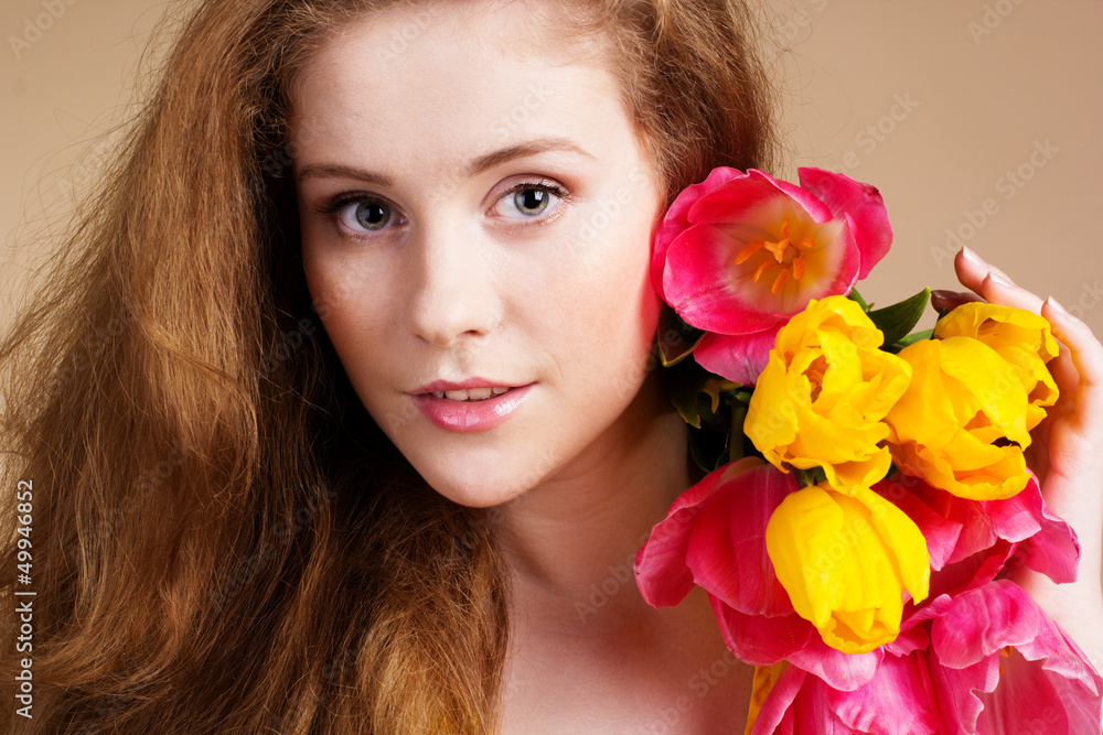 Beautiful redheaded girl with tulips