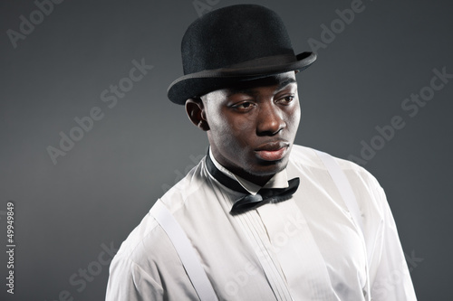 Vintage black american man in suit with hat. Fashion studio shot