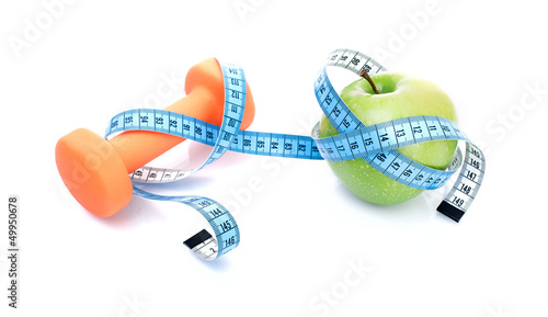 Dumbbell with apple and measure tape, isolated on white photo