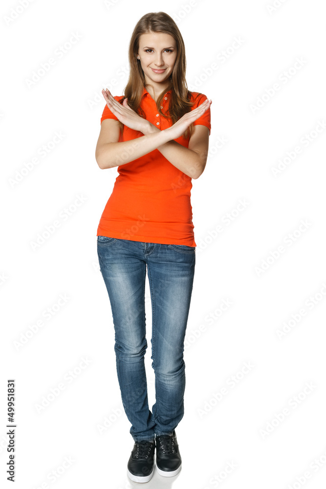 Smiling young woman in full length making stop gesture Smiling young woman in full length making stop gesture