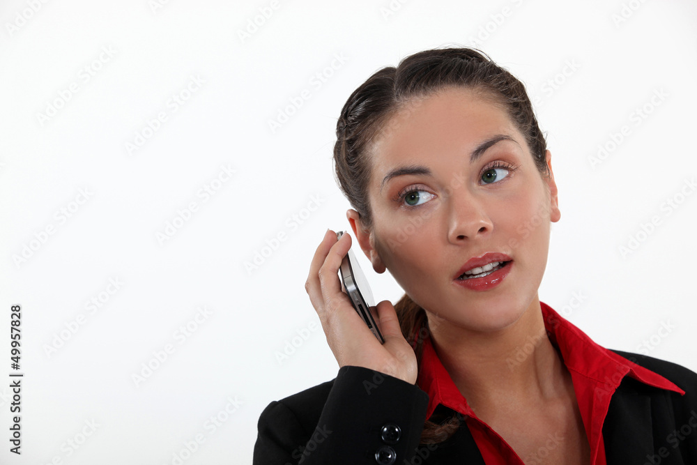 woman with cell phone straining her ears woman with cell phone straining her ears