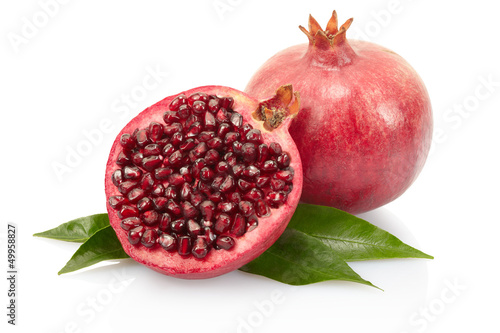 Pomegranate fruit and leaves on white with clipping path