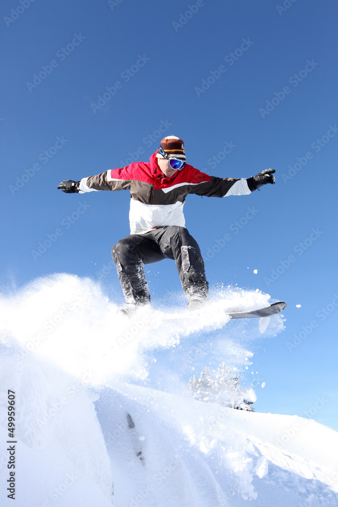 A snowboarder gliding through the air
