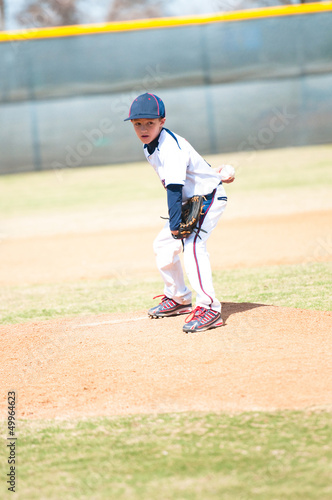Youth baseball pitcher looking.
