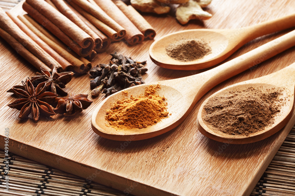 Herbs and Spices over wooden background