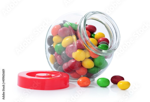 colorful candy in glass bottles isolated on white background