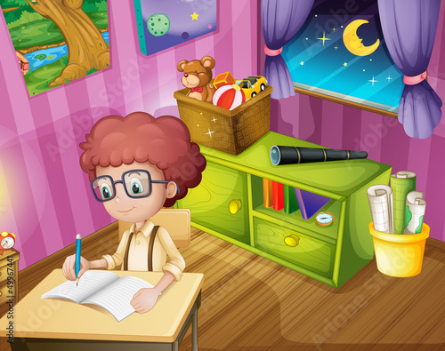 A boy writing inside his room