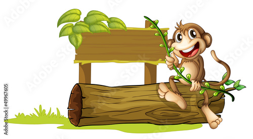 A monkey sitting with a wooden signboard
