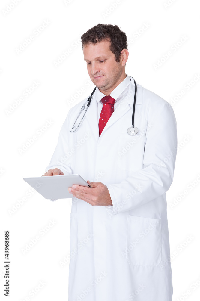 Confident doctor using tablet