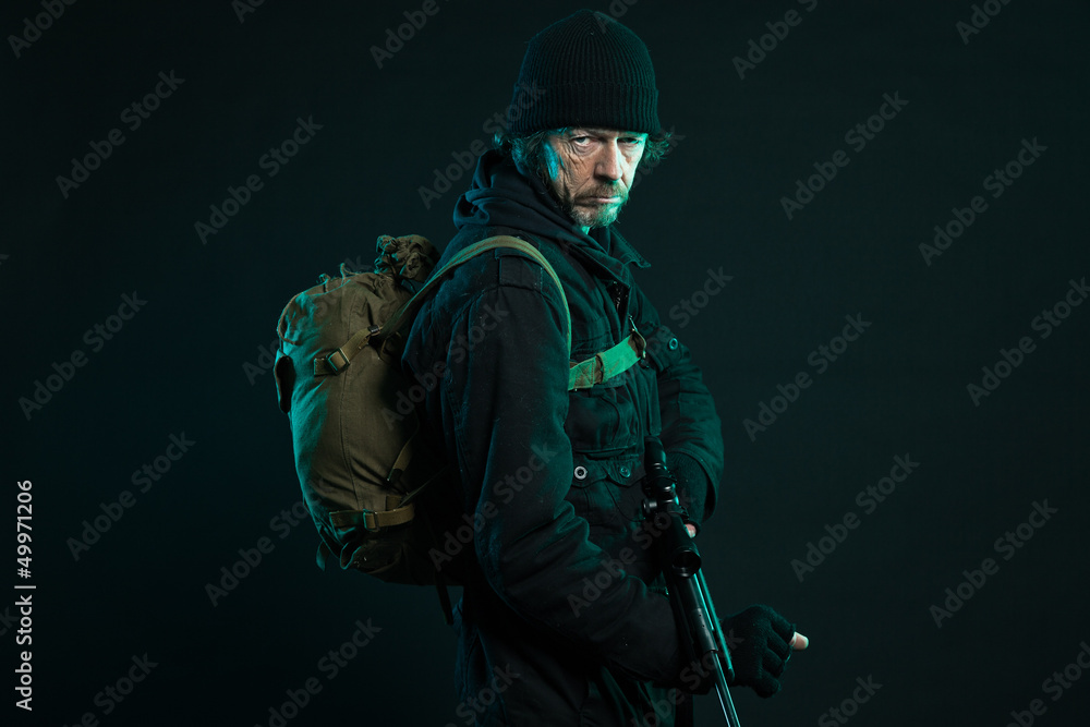 Sniper with beard in black holding gun. Studio shot. Sniper with beard in black holding gun. Studio shot.