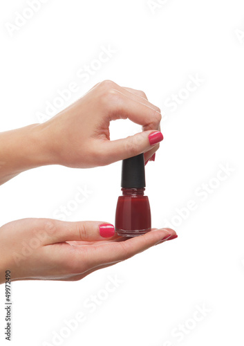 Beautiful female hands holding a bottle of nail polish