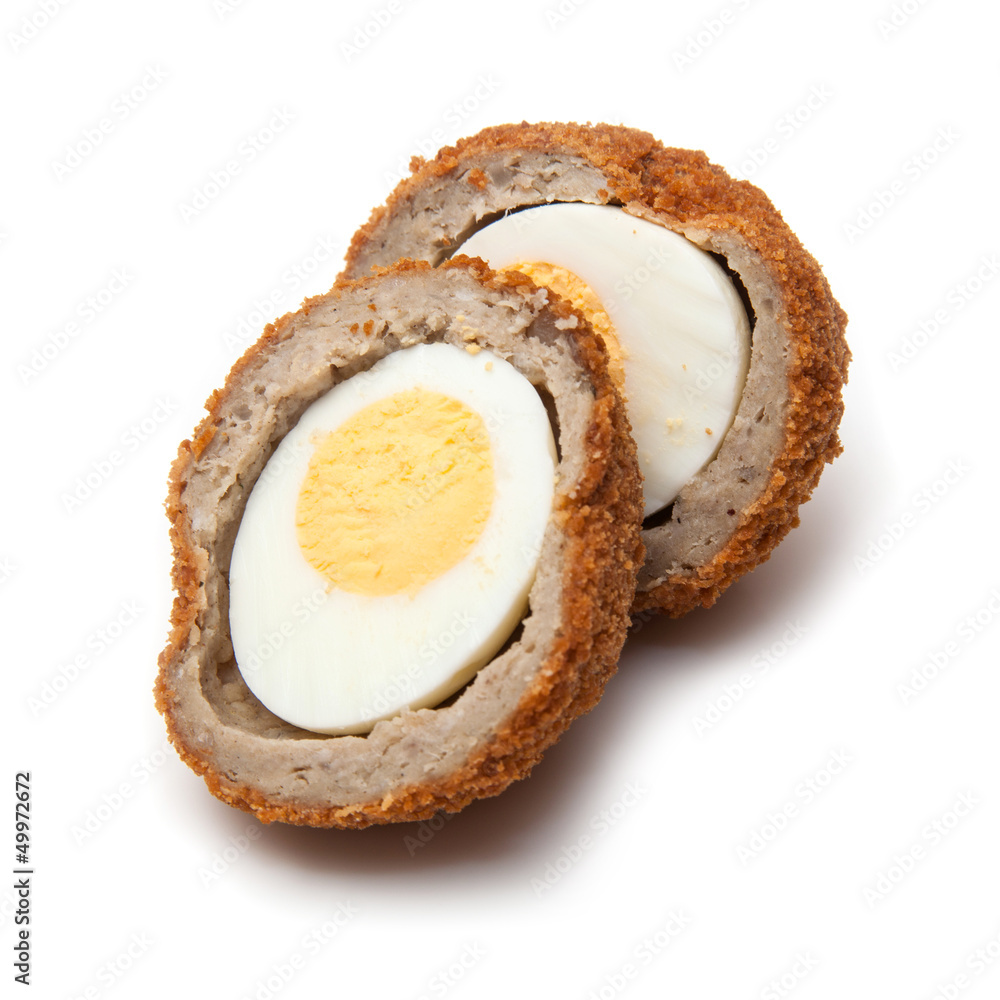 Scotch egg halved and isolated on a white studio background. Scotch egg halved and isolated on a white studio background.