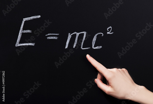 Student hand pointing on phisycs formula. photo