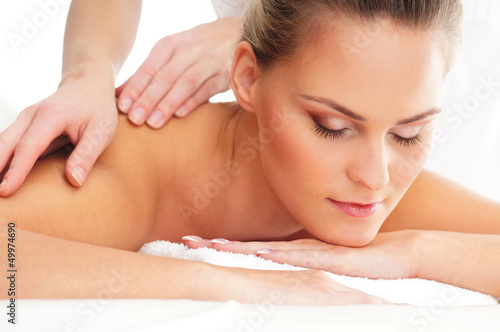 A young woman on a spa back massage procedure