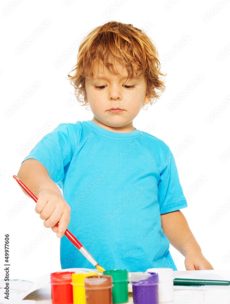 Occupied little boy painting