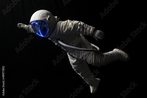astronaut in space mission in the dark and space