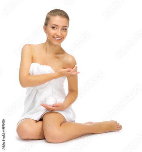 Young girl applying body cream