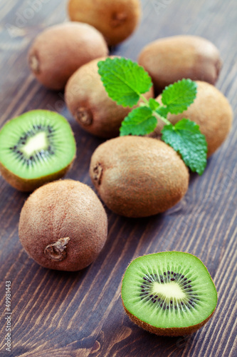 kiwi fruits on a brown wooden table.
