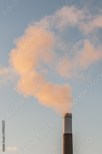smoking chimnney stack in blue sky