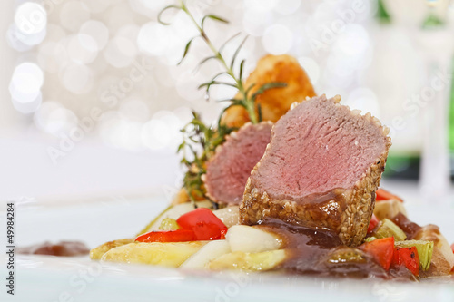 Roasted saddle of lamb on asparagus ragout and herbs