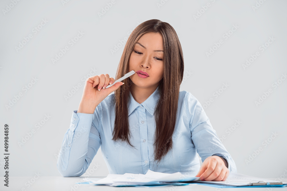 Closeup portrait of a cheerful young businesswoman doing paperwo Closeup portrait of a cheerful young businesswoman doing paperwo