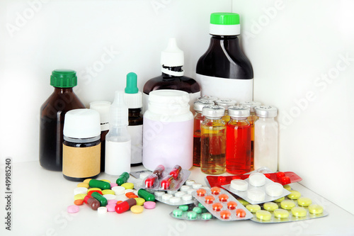 Medical bottles and pills on shelf