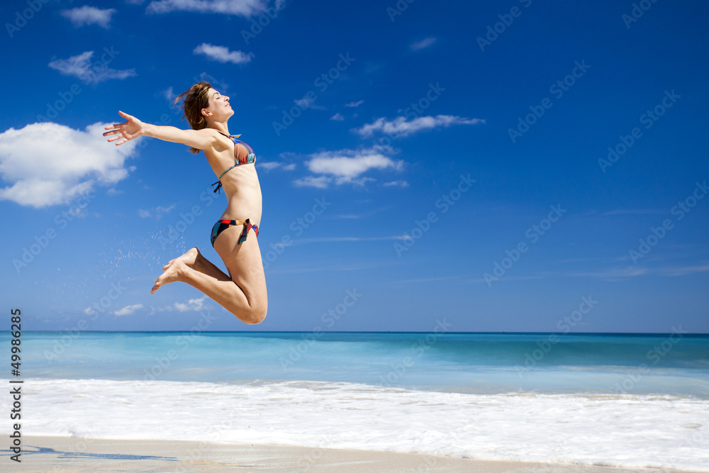 Woman jumping on the beach Woman jumping on the beach
