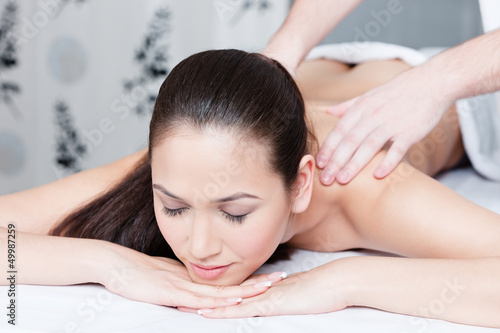 Woman gets massage therapy at spa