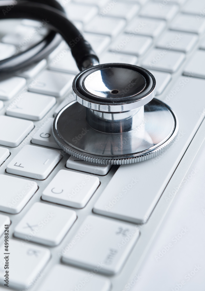 Close up of stethoscope on pc keyboard. Healthcare concept Close up of stethoscope on pc keyboard. Healthcare concept