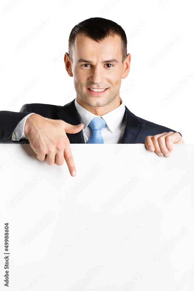 Businessman points with hand at paper copy space, isolated Businessman points with hand at paper copy space, isolated