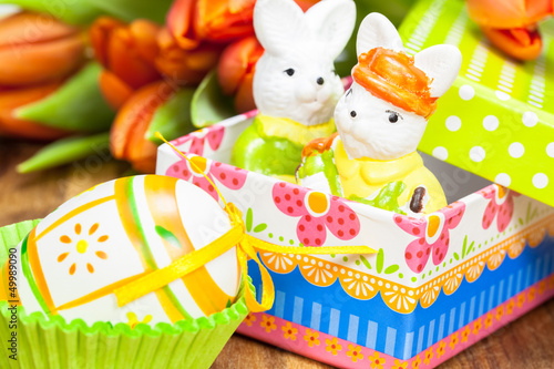 Colorful present and orange tulips. Festive easter decoration