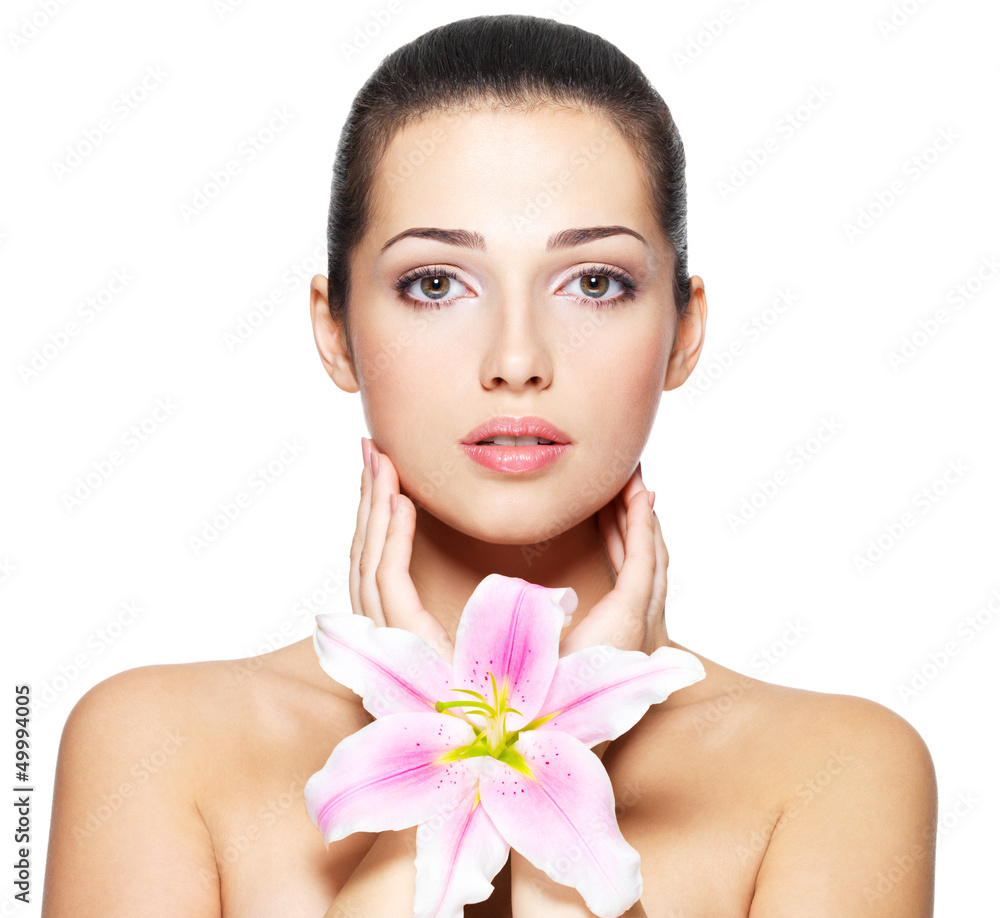 Beauty face of young woman with flower. Beauty treatment concept Beauty face of young woman with flower. Beauty treatment concept